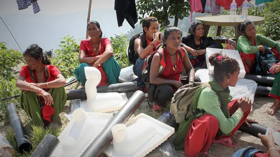 Sita (Mitte) und weitere NachbarInnen inmitten der Bausätze für Stehtoiletten. Foto: Lucia de Vries