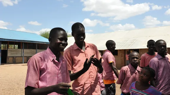 Maliah and Abdulbagi joke with a teacher, as other boys look on - the boy's primary school is mixed with students with and without disabilities learning together. Photos: LWF/ C. KÃ¤stner