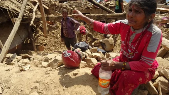 After the earthquake in Nepal, local villager searches for cooking utensils in the debris.  Photo:  LWF/C.Kaestner