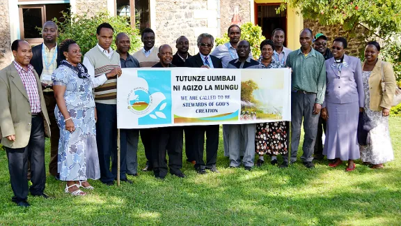 Members of the Marangu Conference pose for a group photo after the blessing for the two climbers with the LWF banner. Photo: David Adgea/ELCC