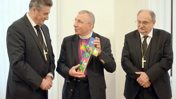 Bishops Ernisa and Filo from Slovenia presented with gift from Bishop Younan (center) at reception in Lutheran Church Ljubljana. Photo: LWF/H. Martinussen