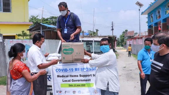 NELC President Rev. Joseph Soren (right) presents packages of medical items and hygiene kits to leaders of Jahada Rural Municipality in Morang district, eastern Nepal. Photo: LCWS/Suman Rai