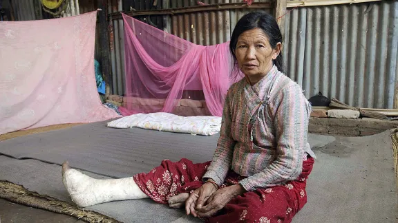 Kanchi Shrestha, 71, mit versorgtem Beinbruch vor ihrer Notunterkunft. Der LWB hat Shrestha und ihrer Familie geholfen und unterstützt sie auch beim Wiederaufbau ihrer Häuser. Foto: LWB Nepal