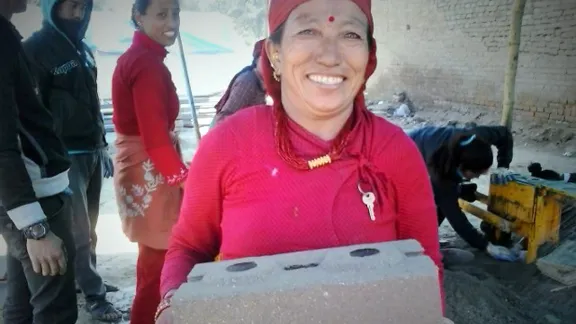 Kabita Shresthaâs friend Kanchhi Shrestha carrying an unfired brick. Photo: LWF/Lucia de Vries