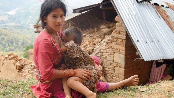 Sapana Roka Sarki, nursing her youngest child in front of her house. She has three children, since their livelihood is gone her husband is looking for work abroad. Photo: LWF/ C. KÃ¤stner