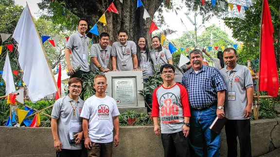 LCP President Rev. Antonio D. Reyes (second right) joins officials of the Philippine Lutheran Youth League and the young reformers at the commemorative plaque renaming the century-old tamarind tree as the LCP Tree. Photo: Ely Hernandez