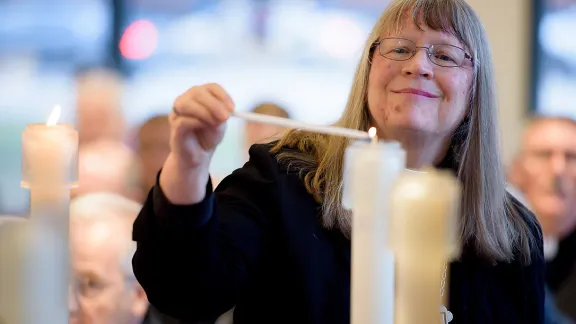 Rev. Jessica Crist, bishop of the Montana Synod of the Evangelical Lutheran Church in America, lights one of the candles for the ecumenical imperatives. Photo: C. Jason Brown/Insight Images