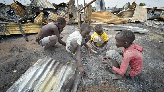 Children look for valuable items in the ashes of what was once the central market in Bor. Photo: Paul Jeffrey/ACT Alliance