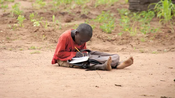 A young boy doing his homework in Yida refugee camp, South Sudan. Photo: LWF/ M. Hyden