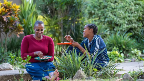 Two friends enjoy a meal on the campus of the ELCT-Diocese of Meru, Usa River Rehabilitation and Training Centre for people with special needs, in Arusha, Tanzania. All photos: LWF/Albin HillertÂ 