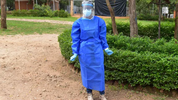 Josephine Nangonzi wearing full protective gear before starting work in the Palorinya refugee settlement in Ugandaâs West Nile region. Photos: LWF/Uganda