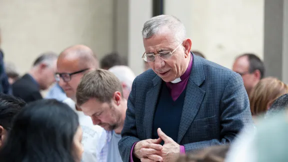 Bishop Dr. Munib Younan, President of the Lutheran World Federation, saying grace at the 2016 LWF Council in Wittenberg. Photo: LWF / Marko Schoeneberg