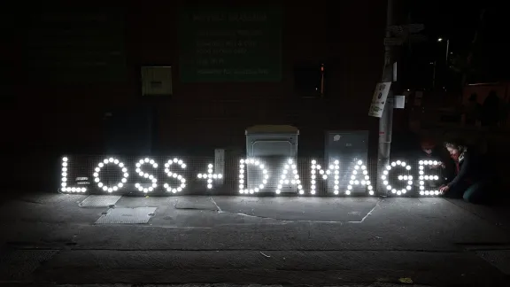 Signs reading “Loss + Damage” outside the venue of COP26 in Glasgow, Scotland. Loss and Damage relate to how rich countries may help developing and poorer countries manage the impacts of climate change on peoples lives as the world needs to transition to build a sustainable future. Photo: LWF/Albin Hillert 