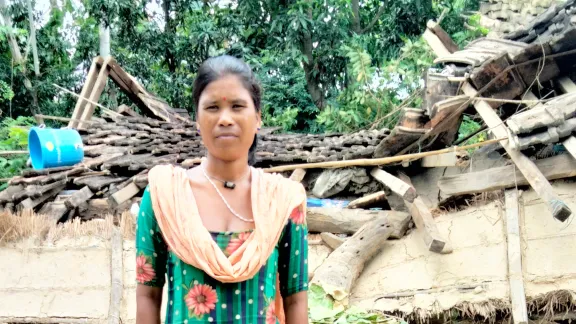 Rekha Chaudhary in front of her house, which was damaged in the floods. Photo: LWF Nepal