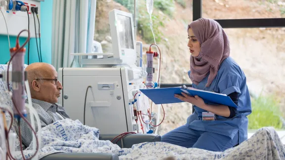 24 February 2020, Jerusalem: Nurse Hiba Almu'ti tends to Shehadi Dar-Awad, as he receives Dialysis treatment at the Augusta Victoria Hospital in Jerusalem. Photo: LWF/Albin Hillert