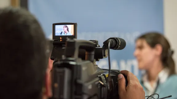 Journalists interview LWF staff at the official launch of ’Waking the Giant’ in Colombia. Photo: LWF/Albin Hillert