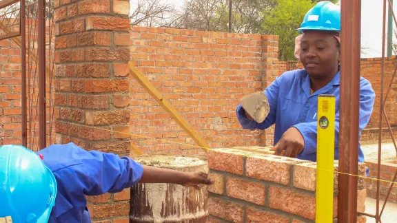 Nomathemba Sibanda displays her masonry skills at the public works site in Filabusi town, southern Zimbabwe. Photo: LWF/Monmo Dahiru Moodi