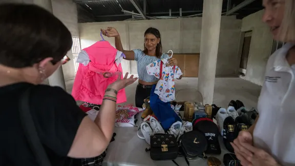 26 October 2023, El Guante, Cedros, Honduras: Alexandra Ochoa from Guaimaca, one of a group of youth receiving support from the Lutheran World Federation World Service program, displays articles of clothing she intends to sell as part of her small-scale business. Photo: LWF/A. Hillert