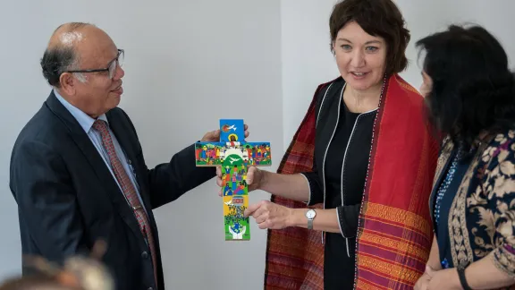 On the first day of visiting member churches in Indonesia, LWF general secretary Rev. Dr Anne Burghardt presents a gift to Batak Christian Community Church Ephorus Bishop Ramses Pandiangan. Photo: LWF/Albin Hillert