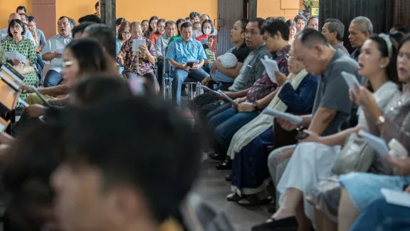 Congregants sing a hymn, including both those seated inside the church building and those in an overflow space provided just outside. Photo: LWF/Albin Hillert