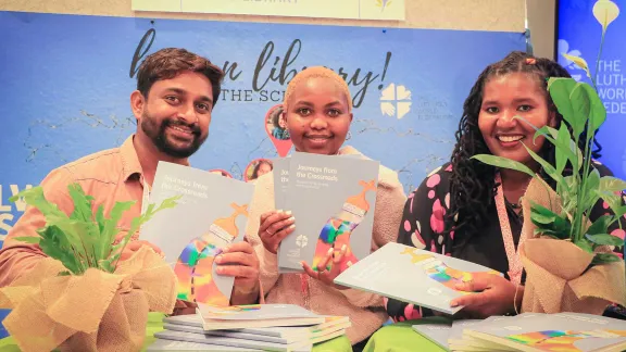 Three LWF scholarship holders at the Thirteenth Assembly in Krakow with copies of the recent publication ‘Journeys from the Crossroads’ which showcases stories on “living, studying and doing theology.” Photo: LWF/J.C. Valeriano