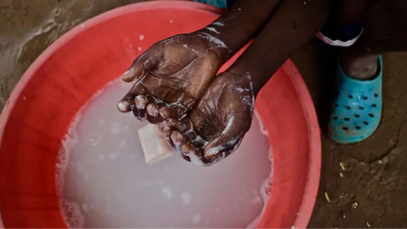 Children demonstrate hand washing at Kakuma refugee camp, Kenya. Photo: LWF/P. Omagwa