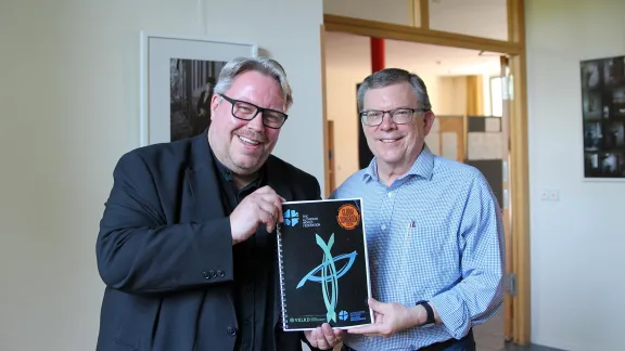 Uwe Steinmetz, who led the project since 2019, and Prof. Dr Dirk Lange, LWF Assistant General Secretary for Ecumenical Relations, showing the prototype of the new Global Songbook. Photo: LWF/A. Weyermüller