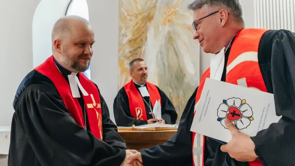 Bishop Leon Novak and Ukrainian Bishop Pavlo Shvarts share the peace at the festive service in St. Catherine’s Lutheran church, Kyiv. Photo: LWF/ Anatolyi Nazarenko