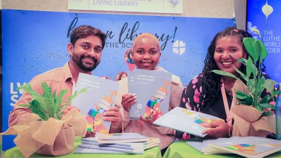 At the LWF Thirteenth Assembly in Kraków, Poland: Scholarship holders display Journeys from the Crossroads, a journal documenting how studying theology has transformed students’ thoughts, lives and faith. Photo: LWF/Johanan Celine Valeriano