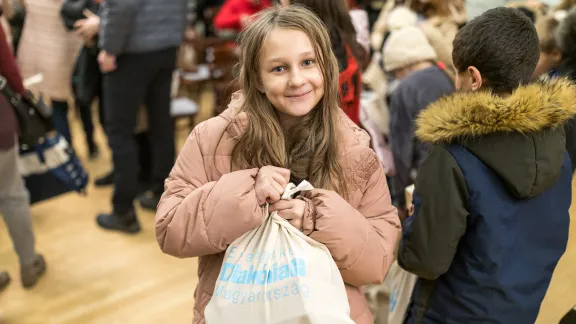 Celebrating holidays like Christmas is part of the school life. A girl holds a bag of sweets for Christmas . Photo: ELCH