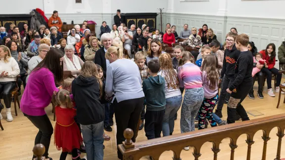 Students perform at a church event. The schools foster integration with local residents. Photo: ELCH