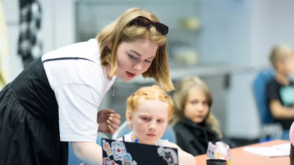 A teacher with her student. The Saturday school helps integrate refugee children into Hungarian schools, while maintaining their identity. Photo: ELCH