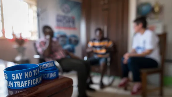 “Say no to human trafficking,” reads a set of wristbands as 36-year-old Harrison Amadi, a returned migrant and participant in Symbols of Hope, shares his story at the project office in Abuja, Nigeria. Photo: LWF/Albin Hillert