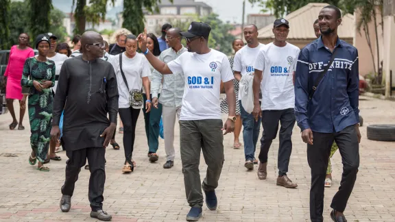 Rev. Emmanuel Subewope Gabriel (left) of the Lutheran Church of Christ in Nigeria, country director of Symbols of Hope Nigeria, in conversation with colleagues and participants at the Symbols of Hope office in Abuja. Photo: LWF/Albin Hillert