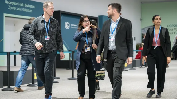 LWF delegates pictured on the opening day of the United Nations climate summit COP29. Left to right: Eugenio Albrecht, Elena Cedillo, and Romario Dohmann. Photo: LWF/Albin Hillert