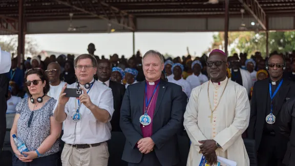 LWF President Bishop Henrik Stubkjær of the Evangelical Lutheran Church in Denmark (mid-right) and Lutheran Church of Christ in Nigeria Archbishop Panti Filibus Musa (right) pictured as people gather for opening service of the 100th annual convention of the LCCN. Also pictured, Bishop Tamás Fabiny of the Evangelical Lutheran Church in Hungary (mid-left) and Katalyn Fabiny (left). 