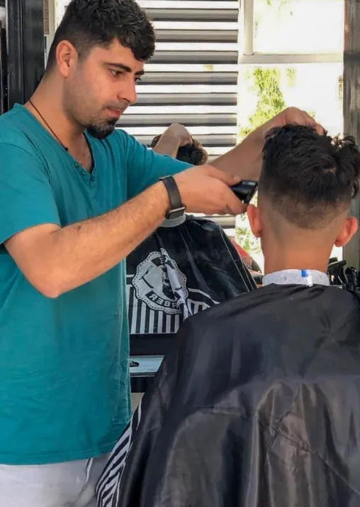 Niyyar Yakoub in his barber shop in Dohuk. Photo: LWF Iraq